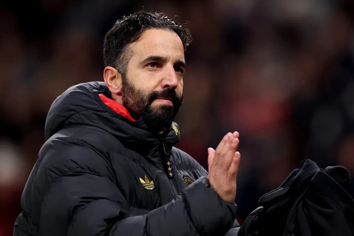 Coach applauding fans in a stadium setting