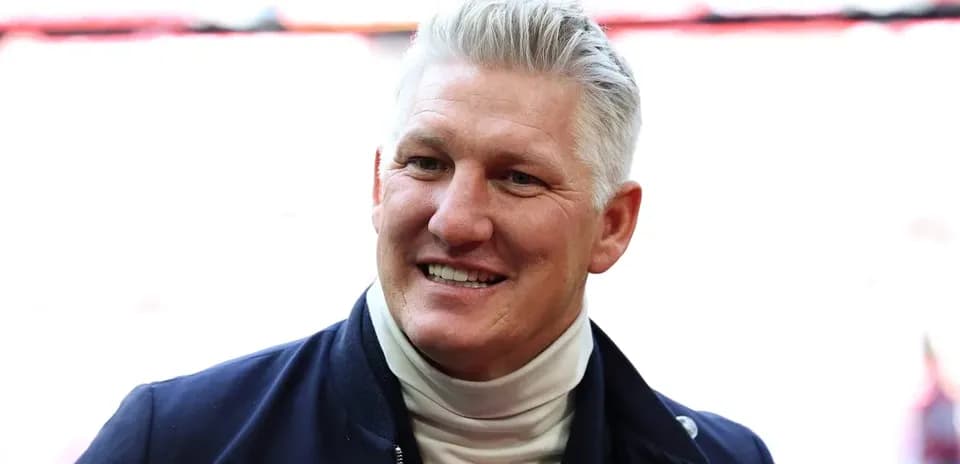 Man smiling in a dark jacket and turtleneck