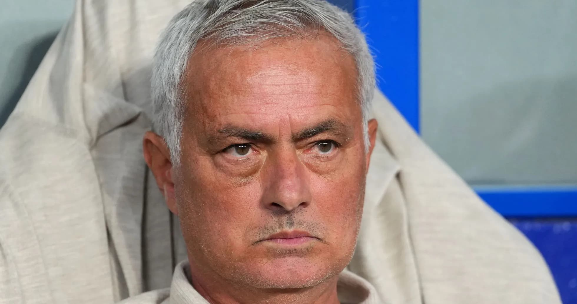 Coach sitting on bench during match