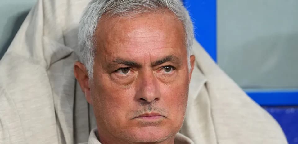 Coach sitting on bench during match