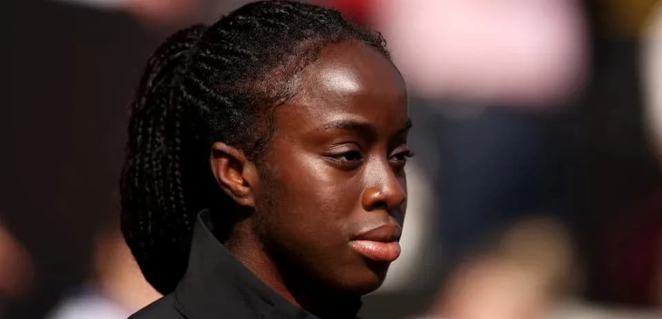 Athlete with braided hair looking focused before event