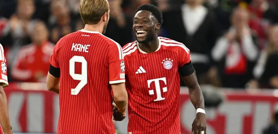 Two Bayern Munich players celebrating on the field