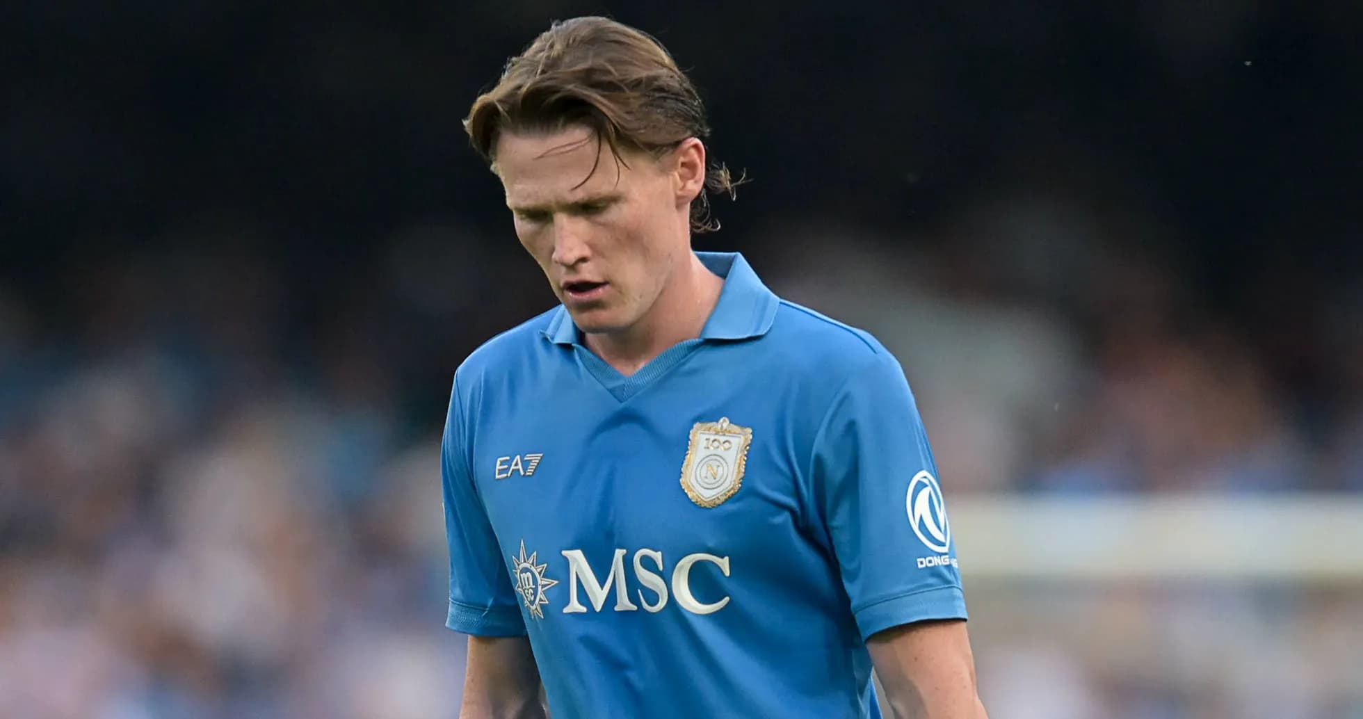 Player in blue jersey looking down during match
