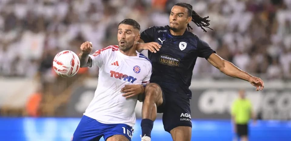 Pafos player challenging HNK Hajduk Split player