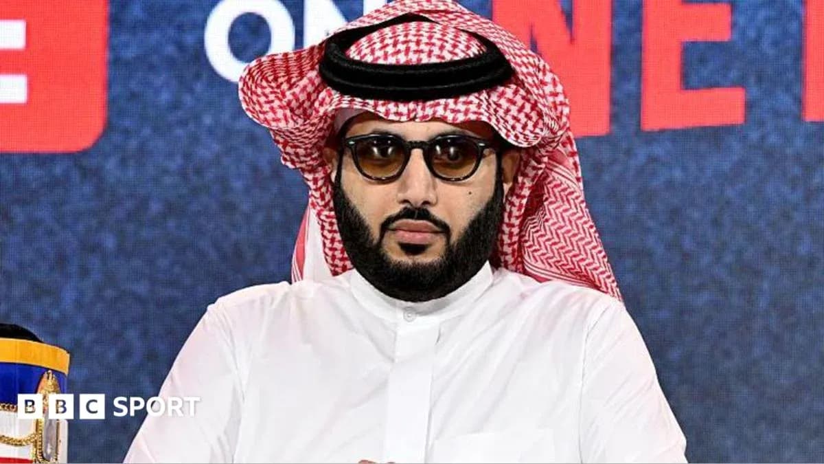 Man in traditional attire at press conference