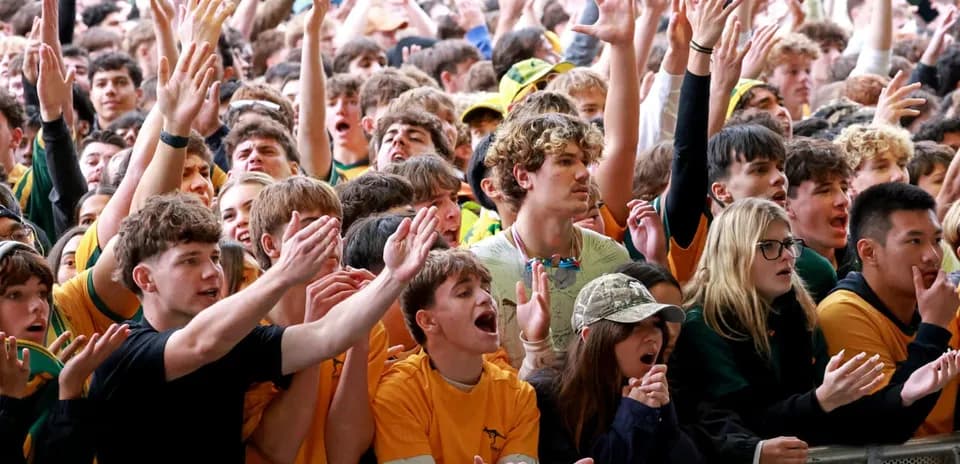 Crowd of fans cheering at a sporting event