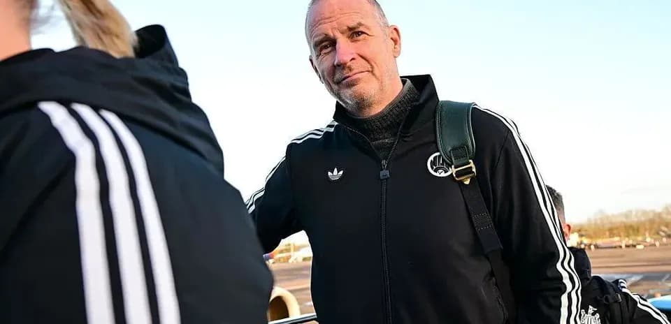 Coach in training gear at airport boarding