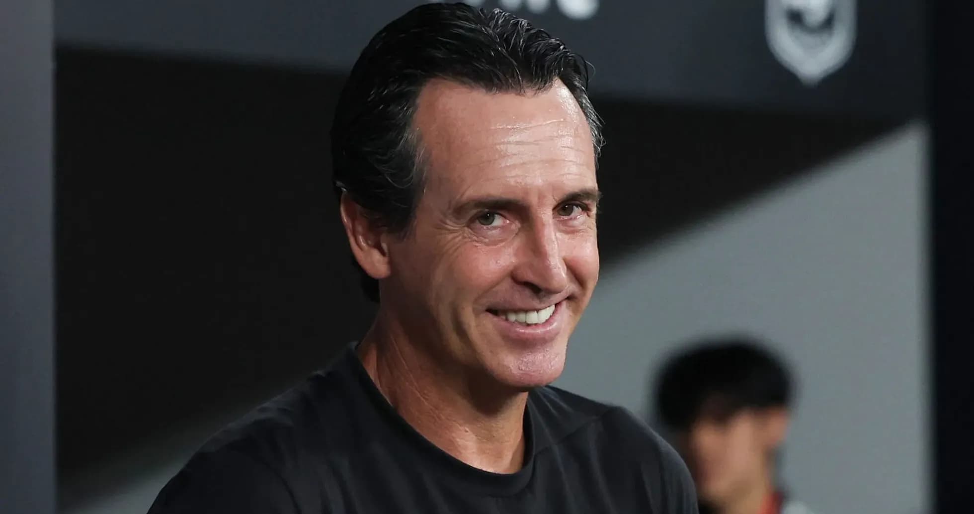 Coach smiling during a match on the sidelines