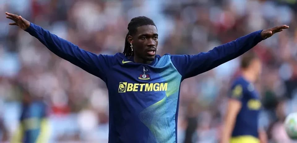 Player warming up with arms extended before match