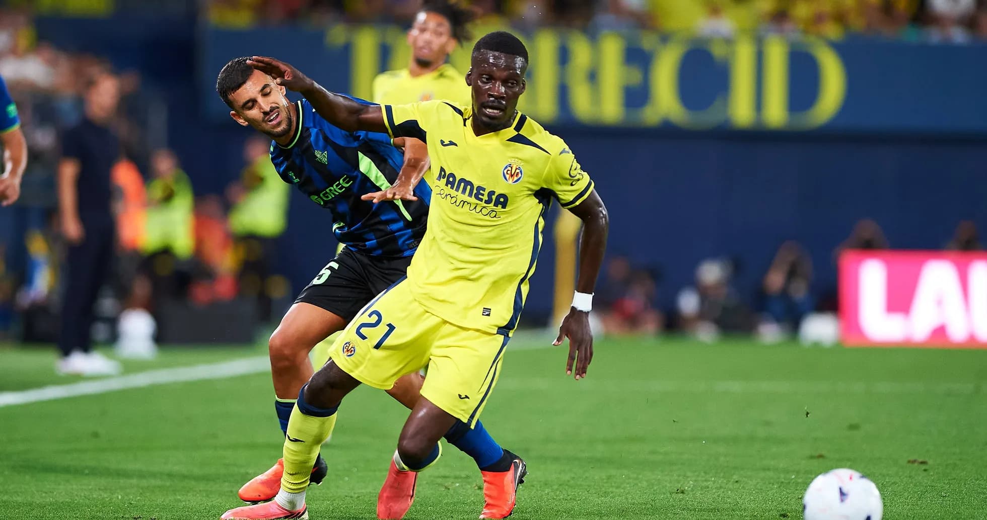 Player in yellow evading opponent in blue during match