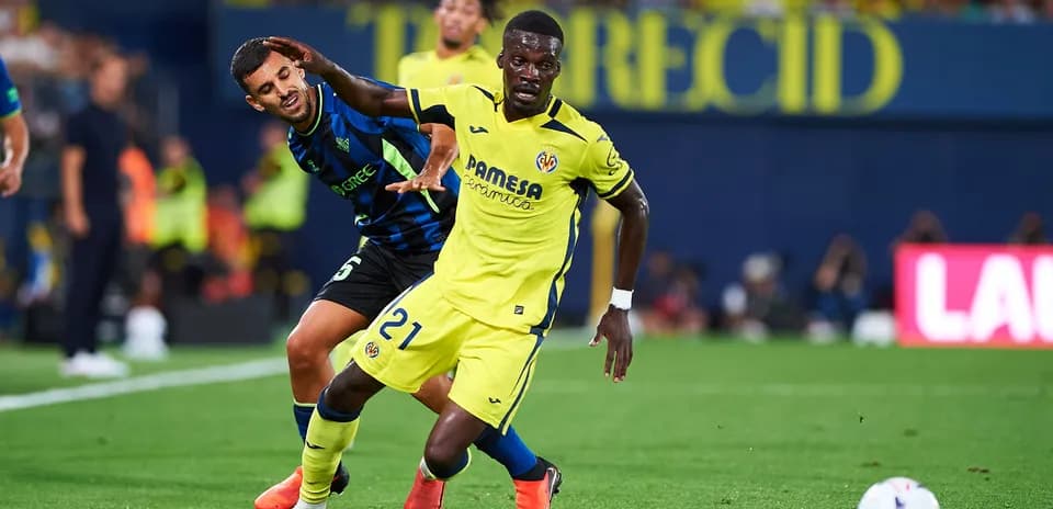 Player in yellow evading opponent in blue during match
