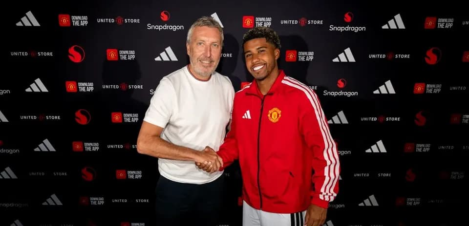 Two men shaking hands at a Manchester United event