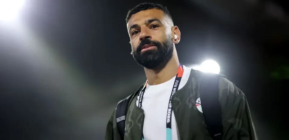 Football player walking with headphones at venue