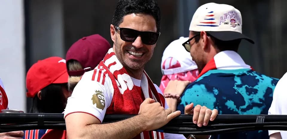 Fan wearing Arsenal scarf at event