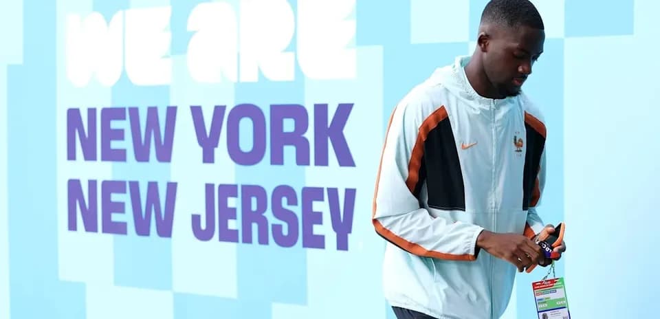 Player walking by wall with 'We Are New York New Jersey' text