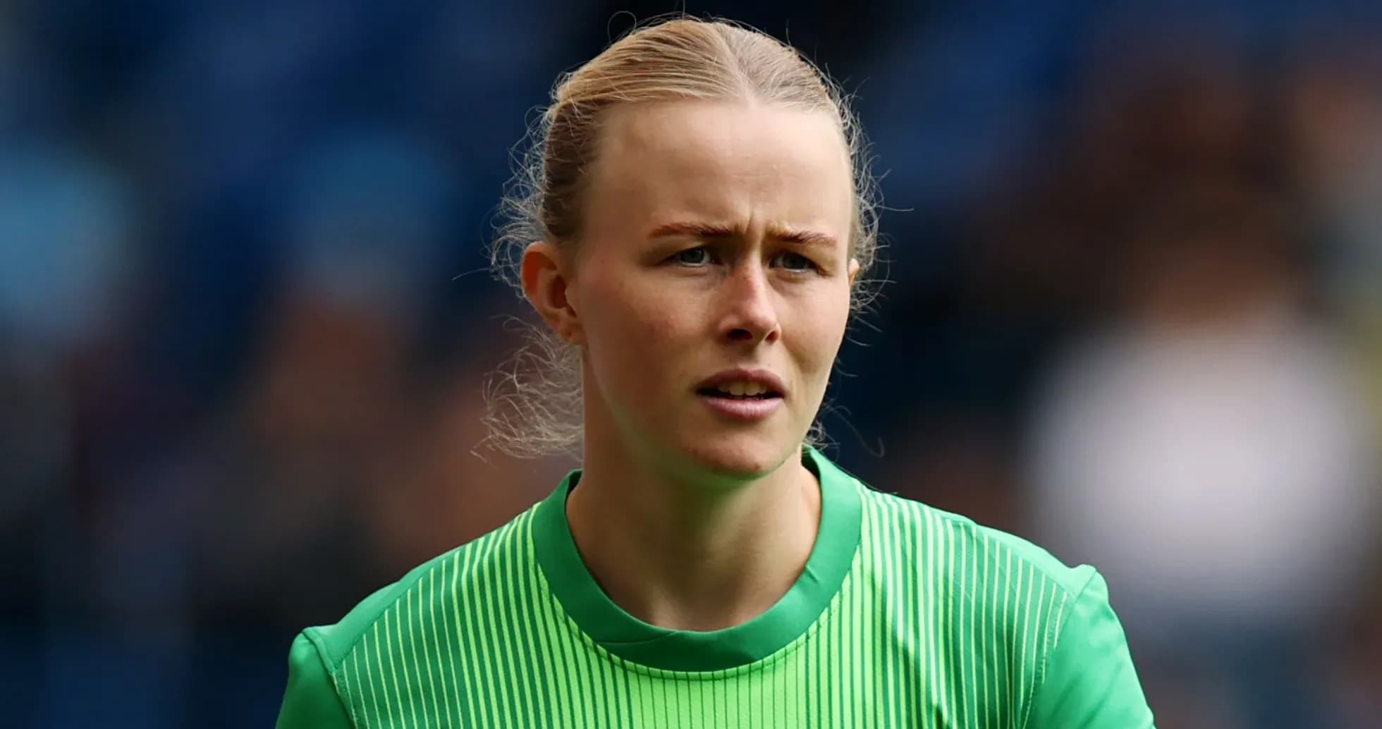 Goalkeeper in green kit during match preparation