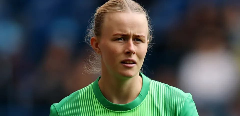 Goalkeeper in green kit during match preparation