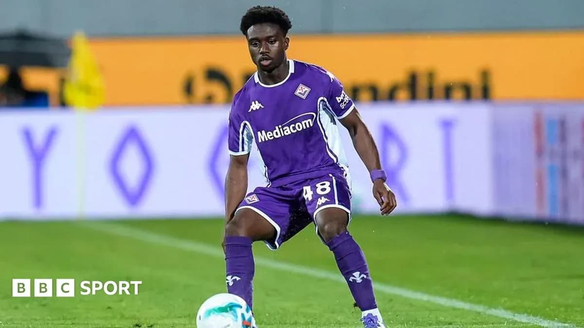 Player in purple kit preparing to pass the ball
