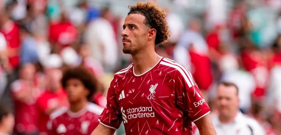 Player in Liverpool jersey walking off the pitch