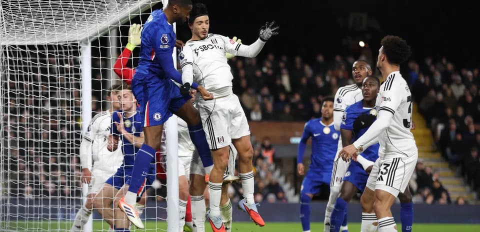 Chelsea player heading the ball during match