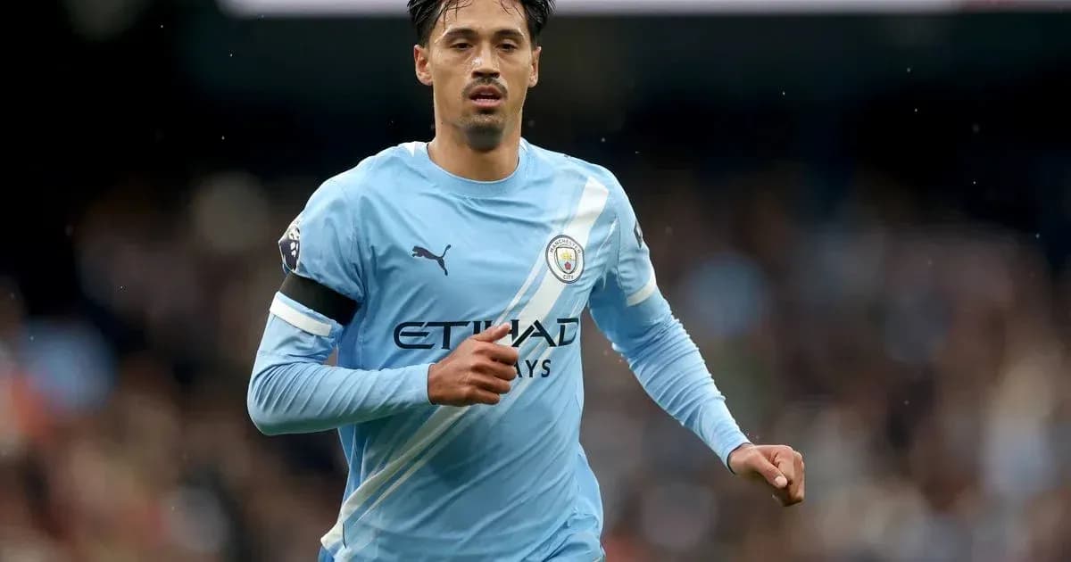 Player running in Manchester City jersey during match