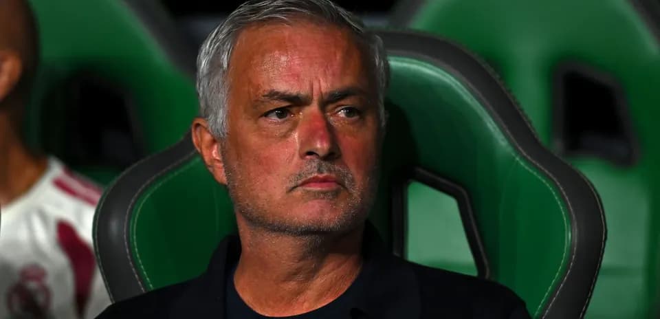 Manager sitting on the bench during a match