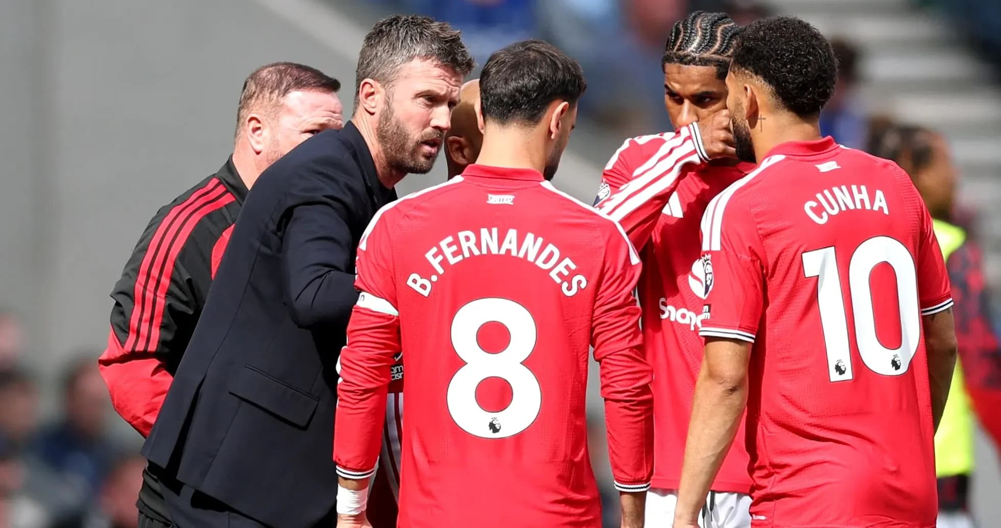 Manager discussing strategy with Manchester United players