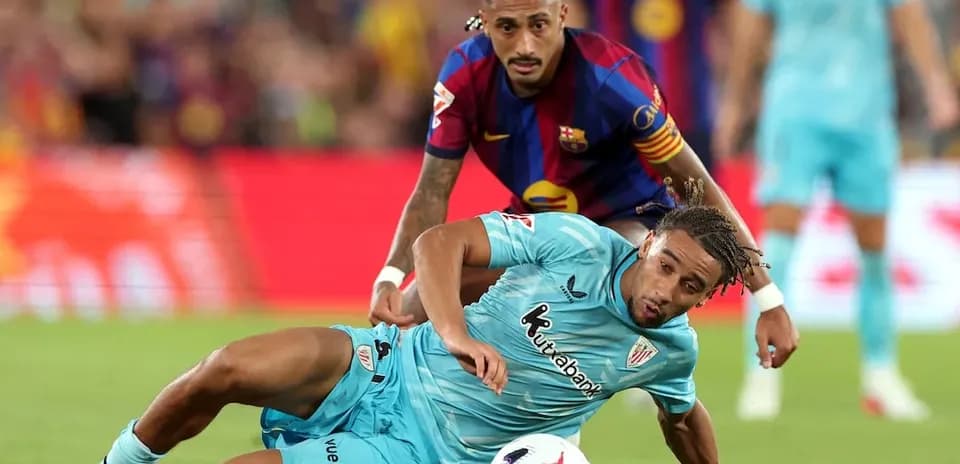 Player tackling on the field during La Liga match