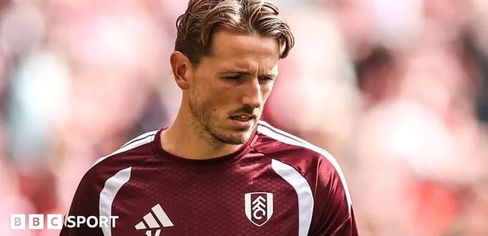 Player in maroon training kit before match