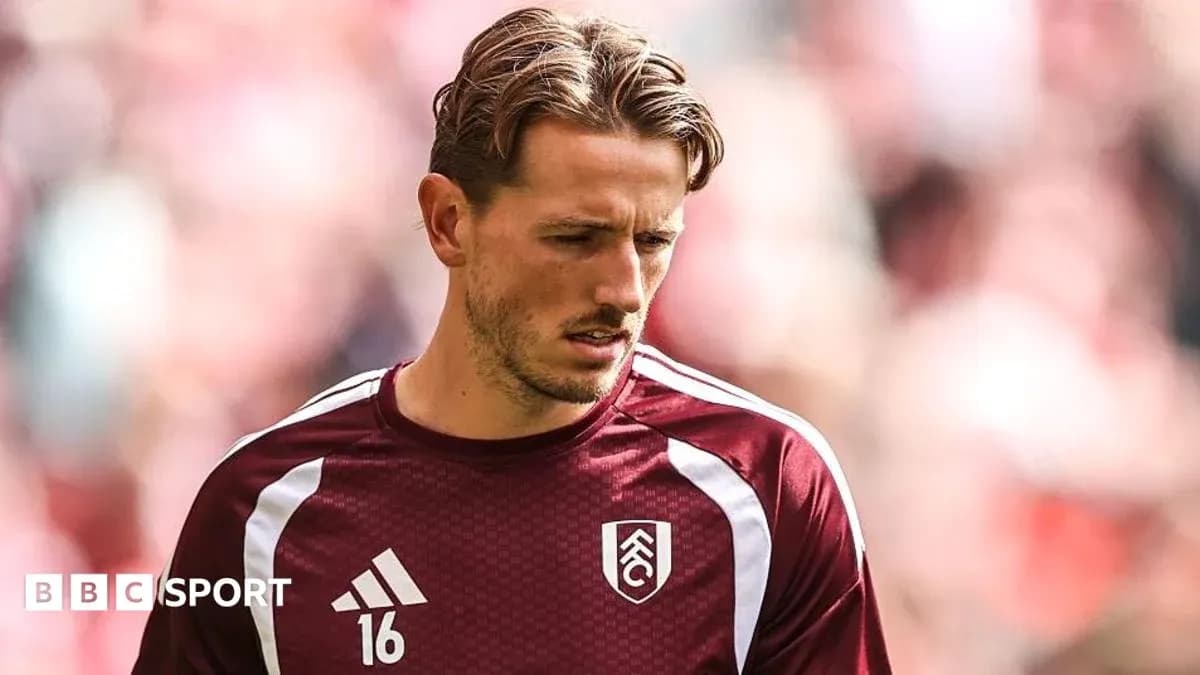Player in maroon training kit before match