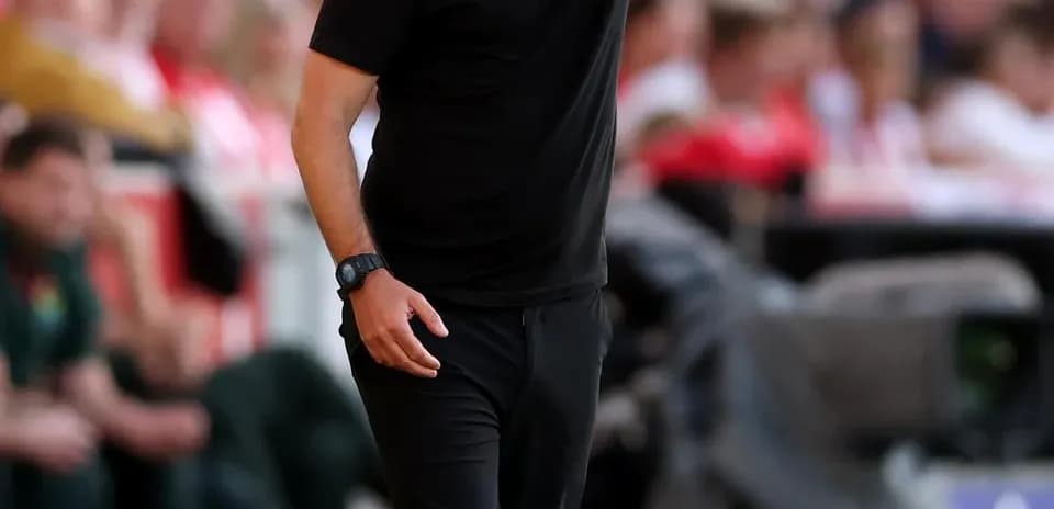 Coach giving instructions during a football match