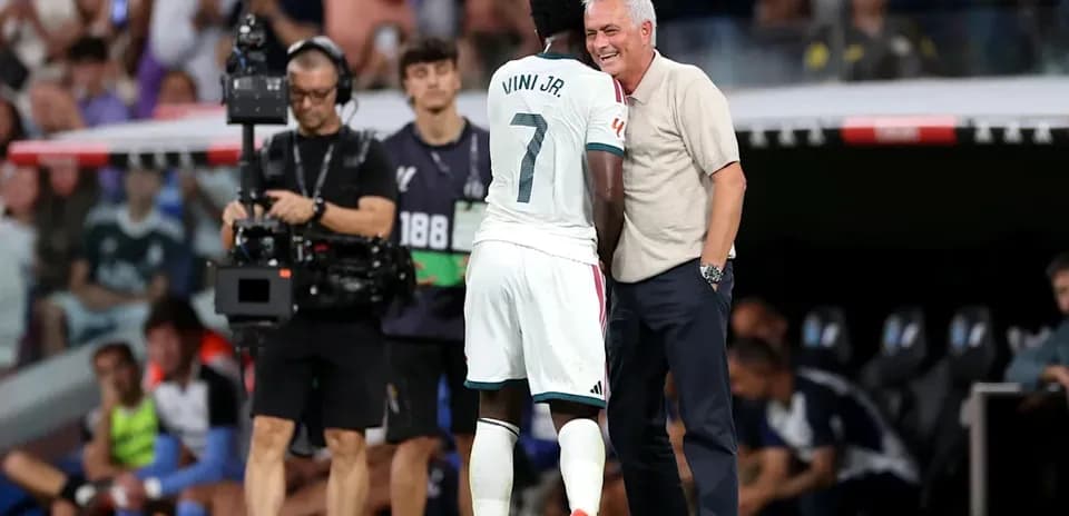 Vinicius Jr. and coach interacting on the sidelines