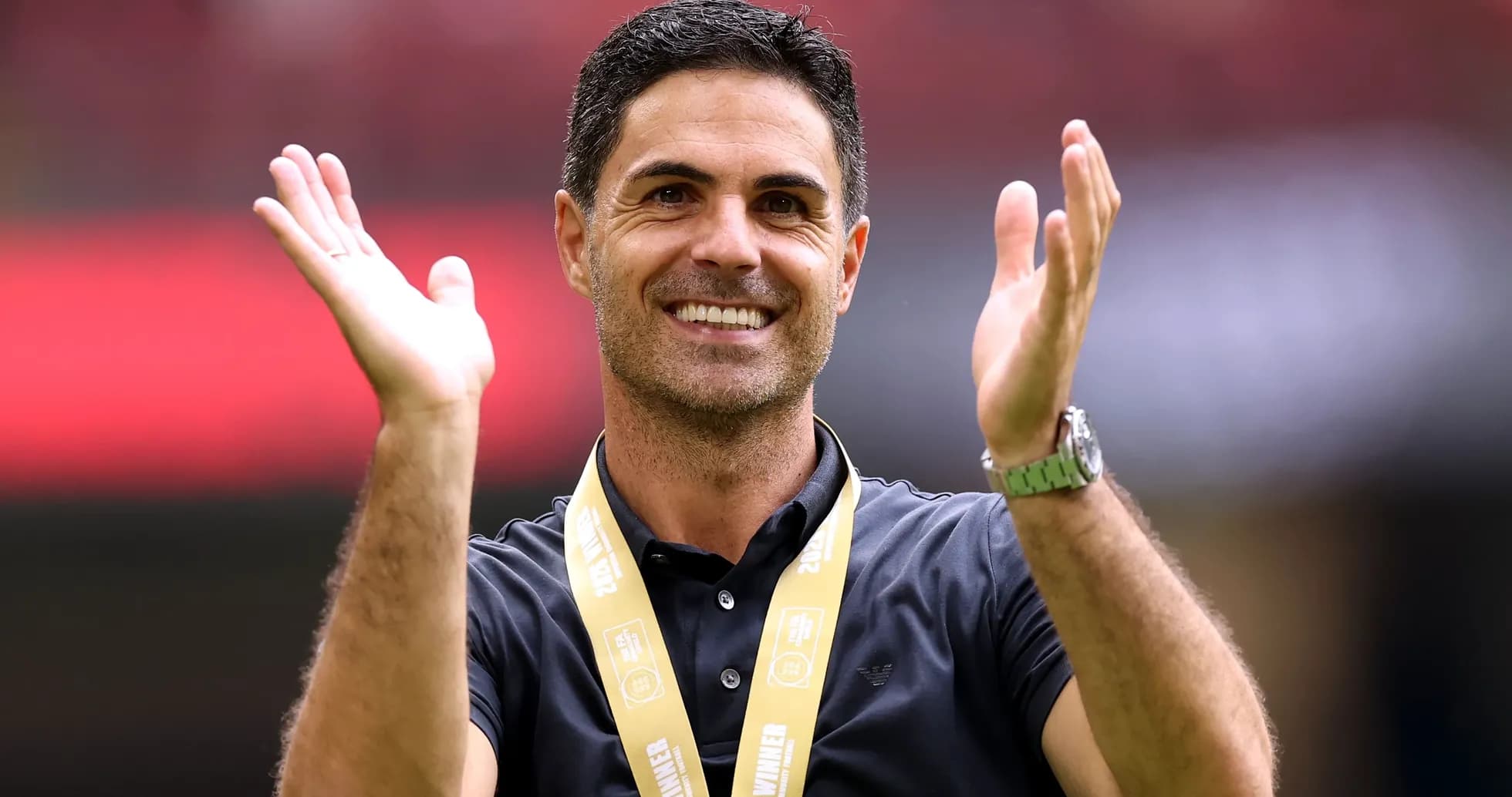 Coach celebrating with a winner's medal