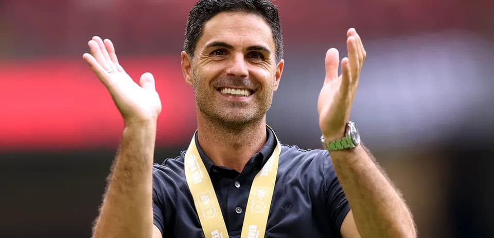 Coach celebrating with a winner's medal