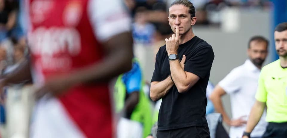 Coach observing match with finger on lips
