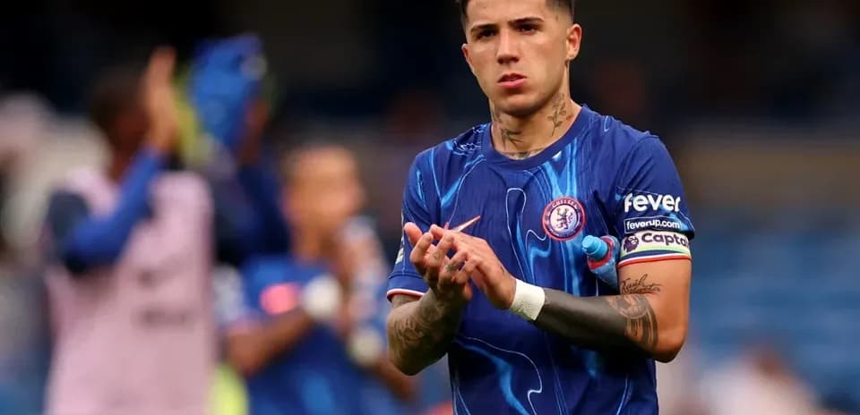Player applauding fans in Chelsea home kit