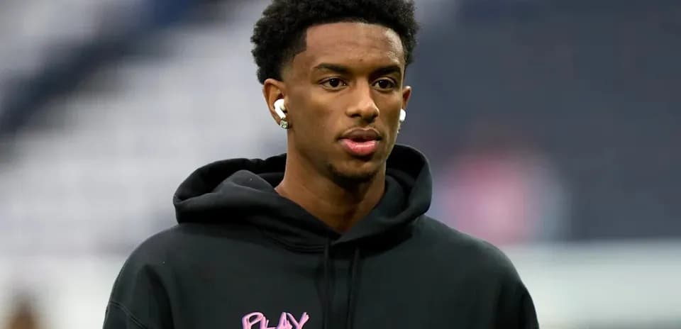 Player wearing hoodie and earbuds before the game