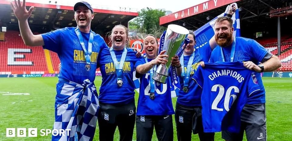 Team celebrating championship victory with trophy and banners