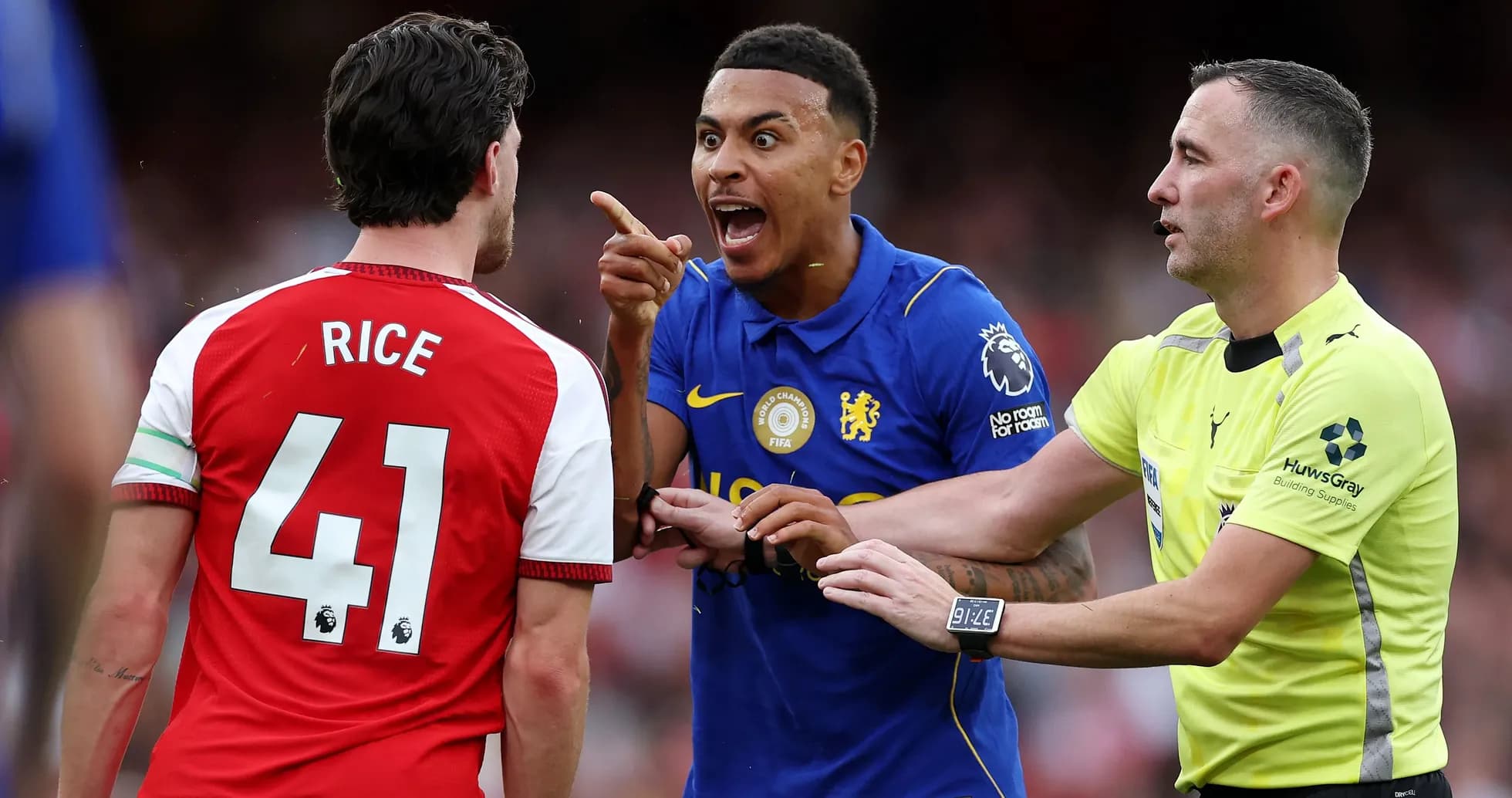 Players arguing during a match with referee intervening