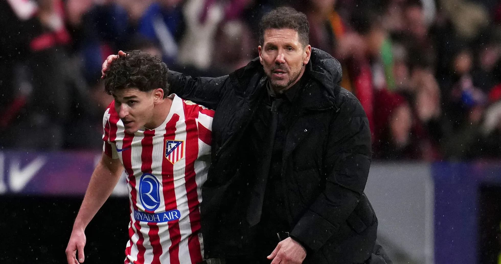 Coach guiding player off the field during match