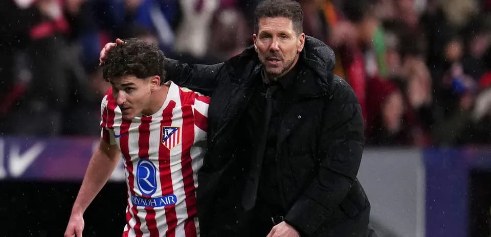 Coach guiding player off the field during match