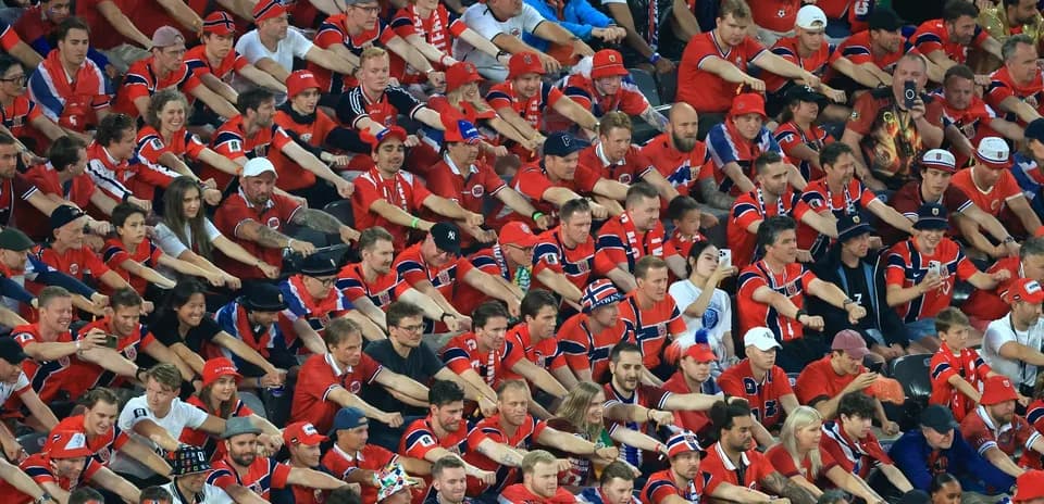 Large crowd of fans wearing red team jerseys