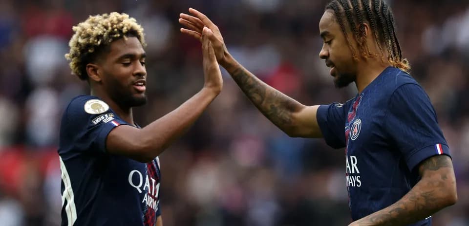 Two PSG players celebrating with a high five
