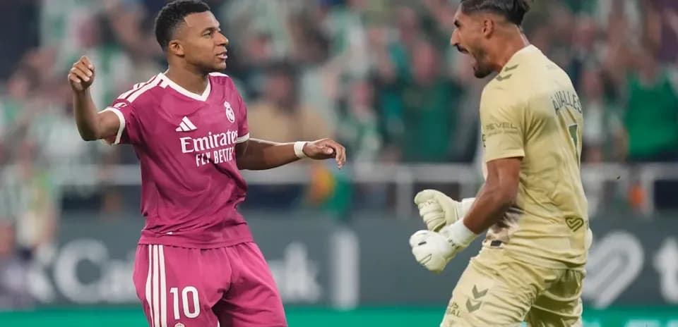 Player celebrating while goalkeeper reacts during match