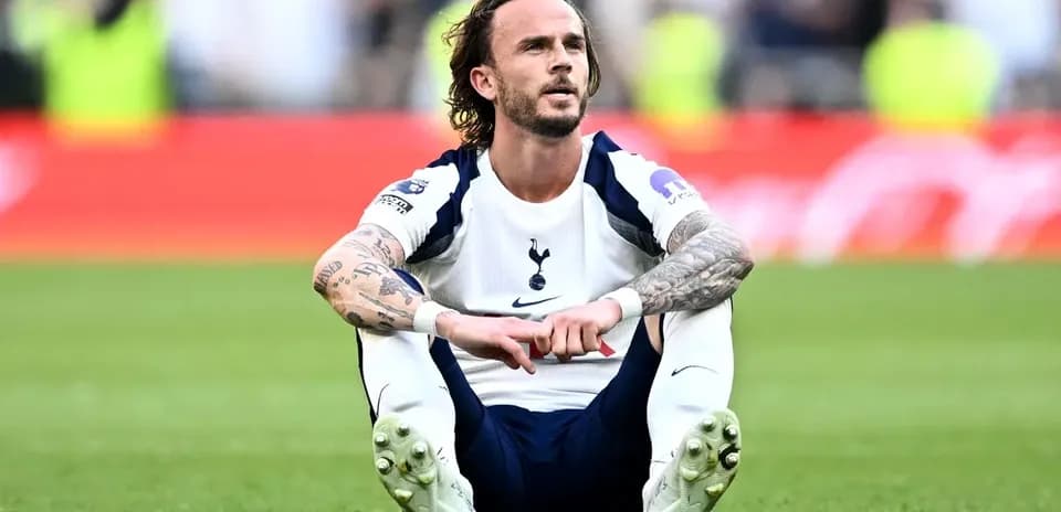 Player sitting on pitch after match conclusion