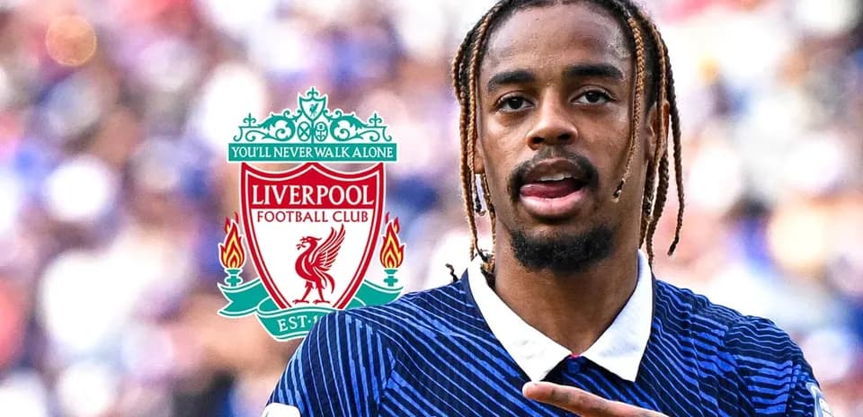 Player gesturing during match with Liverpool logo in background