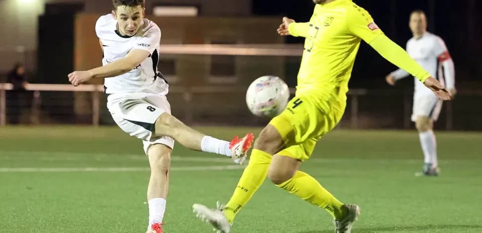 Player kicking the ball during SC St. Tönis match