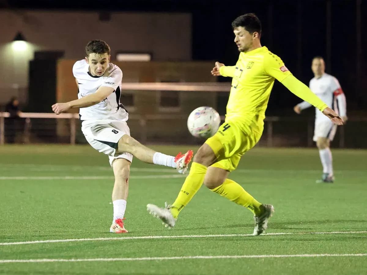 Player kicking the ball during SC St. Tönis match