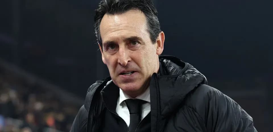 Coach wearing black jacket during match preparation