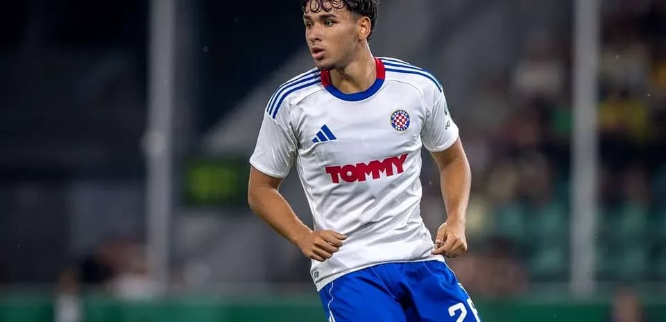 Player in white jersey running on the field